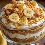 Biscoff Banana Pudding – The Best Creamy Dessert Twist You’ll Love 8 Layered dessert featuring Biscoff Banana Pudding with fresh bananas and cookie butter in a glass bowl
