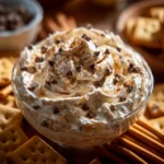 Booty Dip Recipe: Easy, Sweet, and Perfect for Parties 7 Booty Dip dessert with chocolate chips and whipped topping, served in a bowl with animal crackers on the side