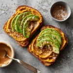 Pumpkin Avocado Toast – Surprising 1-Toast Recipe You’ll Love 7 Top view of pumpkin avocado toast with flax seeds and peanut butter on rustic toast