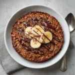 Baked Oats Oatmeal Cake: Healthy, Moist & Ready in 25 Minutes 6 Warm baked oats oatmeal cake in a white ramekin, golden top with soft banana oat center