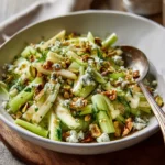 Celery Apple Pistachio Salad – Amazing Texture, 4-Star Flavor 7 Celery apple pistachio salad with blue cheese crumbles and toasted nuts served in a ceramic bowl with a spoon