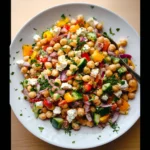 Dense Bean Salad Recipe – 1 Healthy Vegan Meal You’ll Love 7 Overhead view of dense bean salad with chickpeas, cucumbers, bell peppers, red onion, and vegan feta