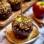 Date Caramel Apple – Sweet, Guilt-Free Indulgence You’ll Love 7 Date Caramel Apple with dark chocolate and chopped peanuts on a small plate with parchment paper
